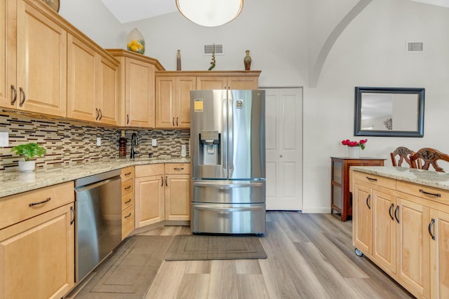 kitchen featuring visible vents, decorative backsplash, light brown cabinets, and stainless steel appliances
