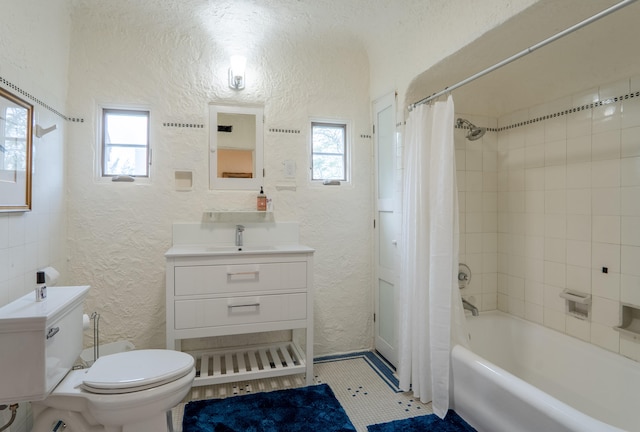 full bathroom featuring shower / tub combo, a textured wall, a healthy amount of sunlight, and toilet