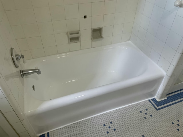full bath featuring a bathing tub and tile patterned floors