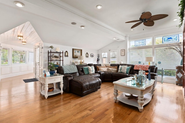 living room featuring ceiling fan, lofted ceiling, a healthy amount of sunlight, and light wood-style flooring