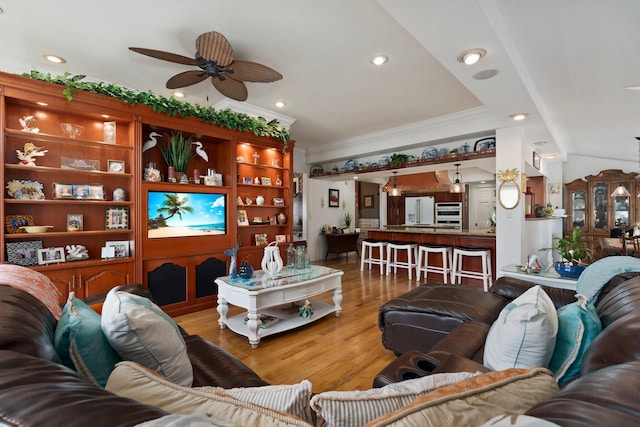 living room featuring ceiling fan, crown molding, wood finished floors, and recessed lighting