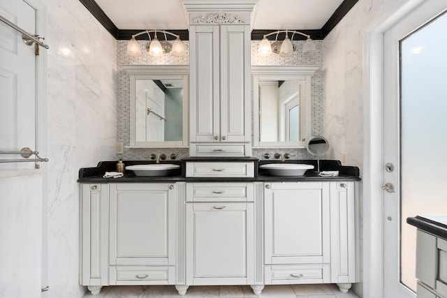 full bathroom featuring ornamental molding, a sink, and double vanity