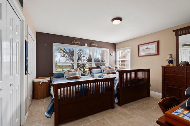 bedroom with baseboards, visible vents, and light tile patterned floors