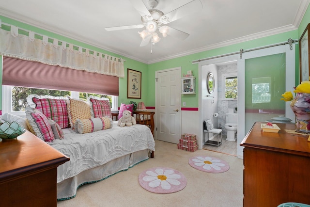 bedroom with a barn door, ornamental molding, carpet flooring, and multiple windows