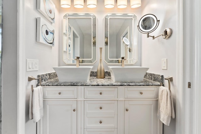 full bath with double vanity and a sink