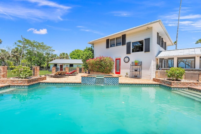 view of pool featuring fence, a patio area, a fenced in pool, and an in ground hot tub