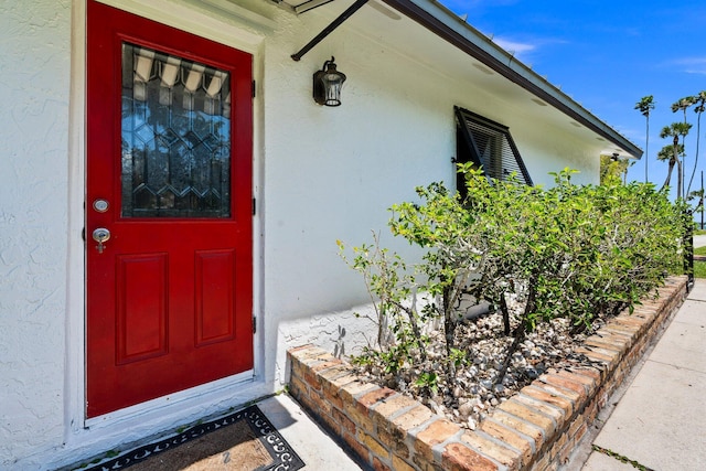 doorway to property with stucco siding