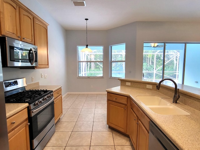 5105 E 1st Sq SW, Vero Beach, FL 32968 - kitchen with light countertops, a sink, a healthy amount of sunlight, and stainless steel appliances