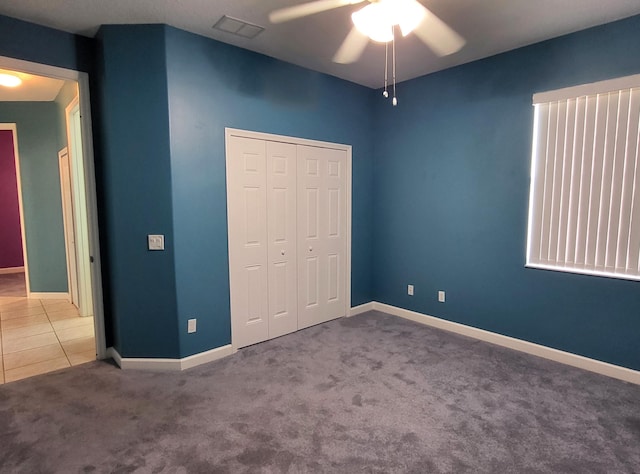 5105 E 1st Sq SW, Vero Beach, FL 32968 - unfurnished bedroom with ceiling fan, visible vents, baseboards, a closet, and carpet
