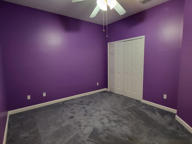 5105 E 1st Sq SW, Vero Beach, FL 32968 - unfurnished bedroom featuring baseboards, ceiling fan, and dark carpet