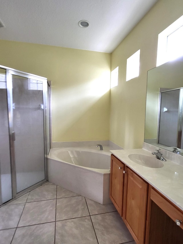 5105 E 1st Sq SW, Vero Beach, FL 32968 - bathroom with vanity, a shower stall, tile patterned floors, and a bath