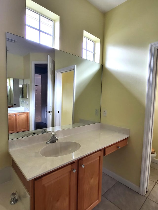 5105 E 1st Sq SW, Vero Beach, FL 32968 - bathroom featuring vanity, tile patterned flooring, baseboards, and toilet