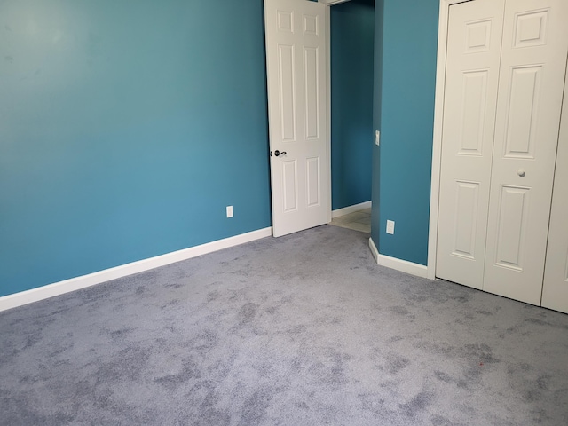 5105 E 1st Sq SW, Vero Beach, FL 32968 - unfurnished bedroom featuring a closet, baseboards, and carpet flooring