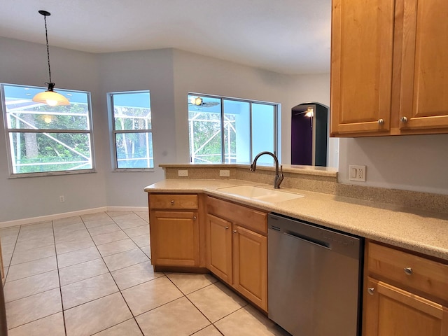 5105 E 1st Sq SW, Vero Beach, FL 32968 - kitchen with stainless steel dishwasher, light countertops, light tile patterned floors, and a wealth of natural light