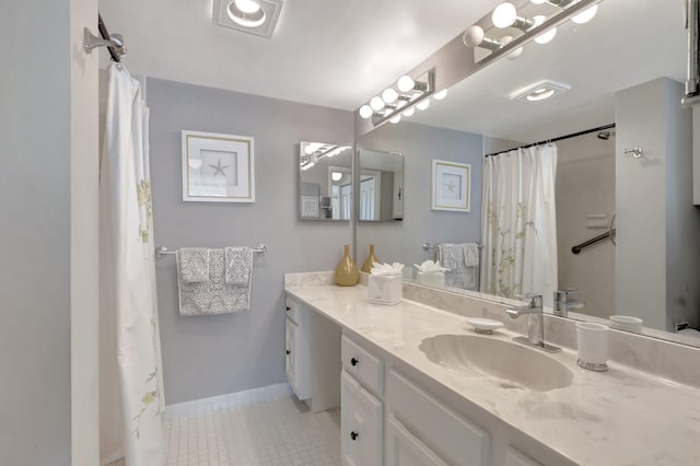 15 Royal Palm Way Unit 505, Boca Raton, FL 33432 - bathroom featuring baseboards, curtained shower, tile patterned flooring, and vanity