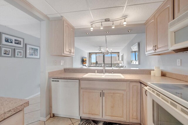 15 Royal Palm Way Unit 505, Boca Raton, FL 33432 - kitchen with light brown cabinetry, a sink, light tile patterned floors, light countertops, and white appliances