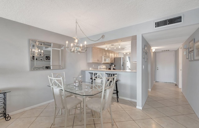 15 Royal Palm Way Unit 505, Boca Raton, FL 33432 - dining area with a notable chandelier, visible vents, light tile patterned floors, and rail lighting