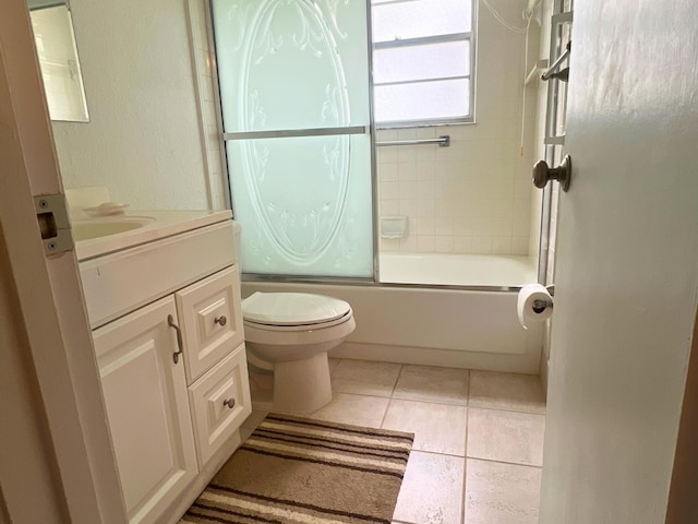 bathroom with toilet, vanity, shower / bath combination with glass door, and tile patterned flooring