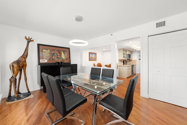 4301 N Ocean Blvd Unit 203, Boca Raton, FL 33431 - dining space featuring baseboards, light wood finished floors, and visible vents