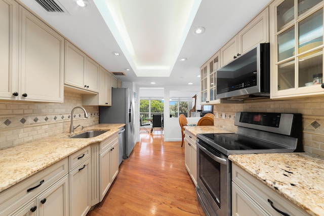 4301 N Ocean Blvd Unit 203, Boca Raton, FL 33431 - kitchen with a sink, tasteful backsplash, visible vents, light wood-style floors, and appliances with stainless steel finishes