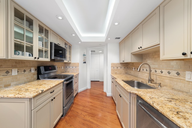 4301 N Ocean Blvd Unit 203, Boca Raton, FL 33431 - kitchen featuring stainless steel appliances, backsplash, visible vents, a sink, and light wood-style floors