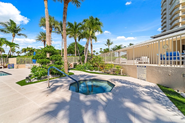 4301 N Ocean Blvd Unit 203, Boca Raton, FL 33431 - view of swimming pool featuring a swimming pool, a patio area, a hot tub, and fence