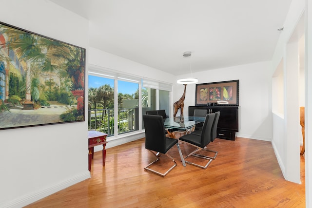 4301 N Ocean Blvd Unit 203, Boca Raton, FL 33431 - dining room featuring baseboards and light wood-type flooring