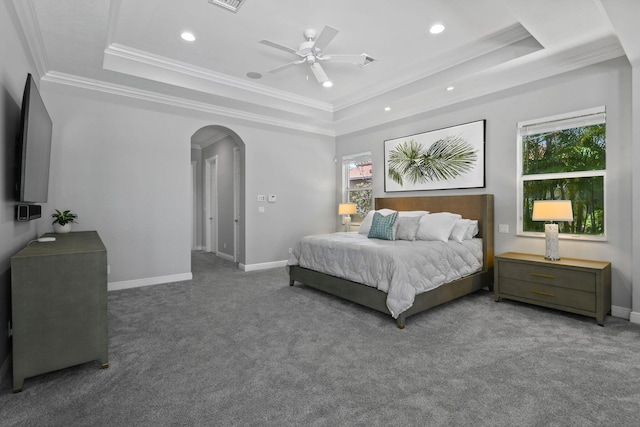 869 SW Habitat Ln, Palm City, FL 34990 - bedroom featuring a tray ceiling, arched walkways, multiple windows, ornamental molding, and recessed lighting