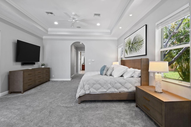 869 SW Habitat Ln, Palm City, FL 34990 - carpeted bedroom with a tray ceiling, arched walkways, crown molding, baseboards, and recessed lighting