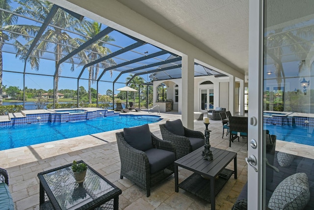 869 SW Habitat Ln, Palm City, FL 34990 - view of swimming pool featuring a pool with connected hot tub, a patio area, outdoor lounge area, and glass enclosure