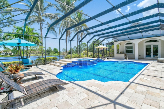 869 SW Habitat Ln, Palm City, FL 34990 - view of swimming pool featuring french doors, a patio, a pool with connected hot tub, and a lanai