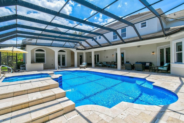 869 SW Habitat Ln, Palm City, FL 34990 - swimming pool featuring outdoor lounge area, french doors, an in-ground hot tub, a patio, and glass enclosure