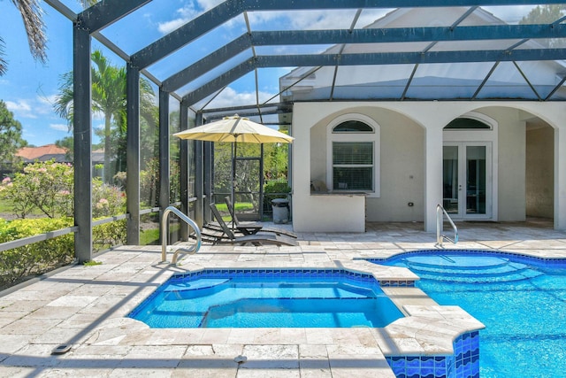 869 SW Habitat Ln, Palm City, FL 34990 - view of pool featuring french doors, a patio area, a lanai, and a pool with connected hot tub