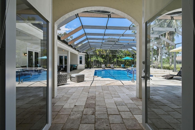 869 SW Habitat Ln, Palm City, FL 34990 - view of pool featuring a pool with connected hot tub, a patio area, and glass enclosure