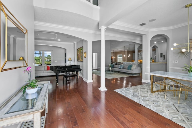 869 SW Habitat Ln, Palm City, FL 34990 - entryway with decorative columns, wood finished floors, ornamental molding, arched walkways, and baseboards