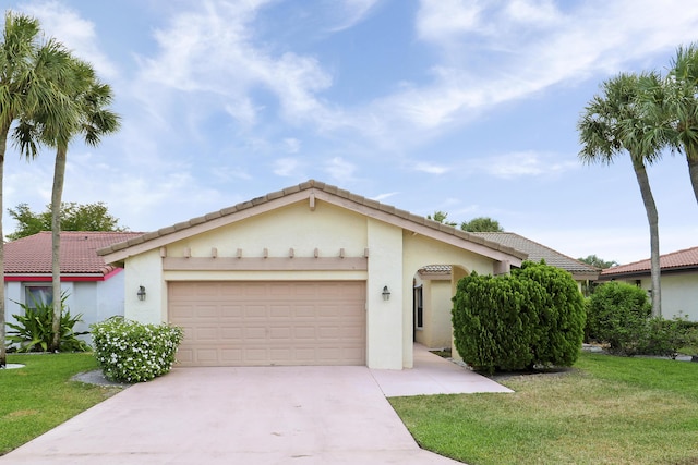 view of front of property with a garage, concrete driveway, a front lawn, stucco siding, and a tile roof