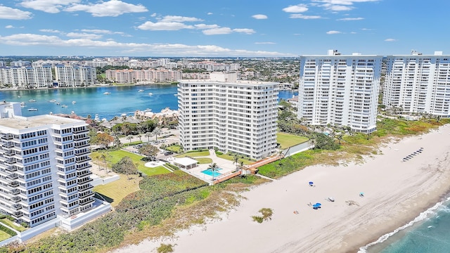 drone / aerial view with a beach view, a city view, and a water view