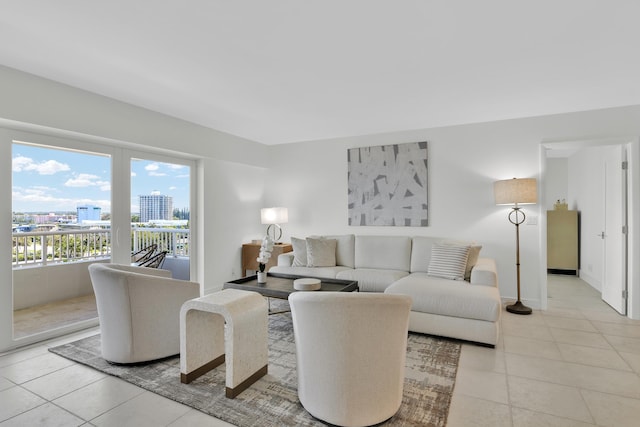 living room with a city view, baseboards, and light tile patterned floors