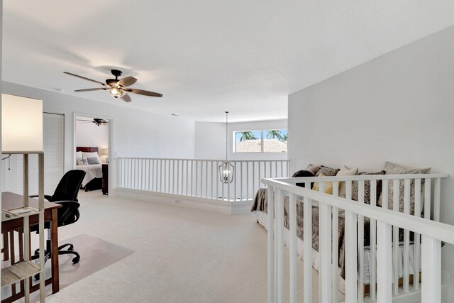 office area featuring ceiling fan and light carpet
