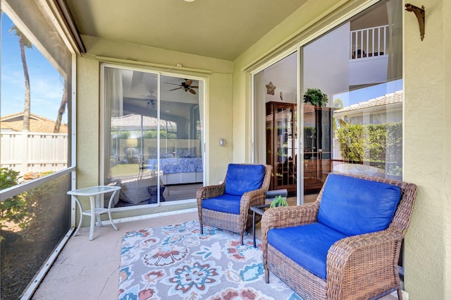 sunroom featuring ceiling fan