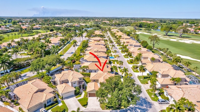 drone / aerial view featuring a residential view and golf course view
