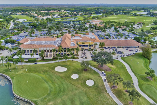drone / aerial view with view of golf course, a water view, and a residential view