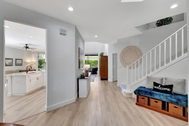 entrance foyer featuring stairway, ceiling fan, light wood-style flooring, baseboards, and recessed lighting