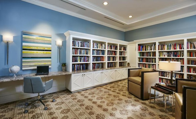 living area featuring ornamental molding, light carpet, recessed lighting, built in study area, and bookshelves