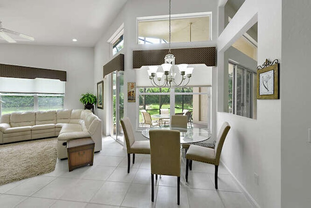 dining area featuring recessed lighting, light tile patterned flooring, high vaulted ceiling, and ceiling fan with notable chandelier