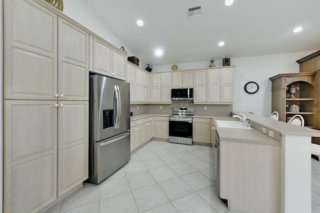 11654 Caracas Blvd, Boynton Beach, FL 33437 - kitchen featuring light countertops, a peninsula, appliances with stainless steel finishes, and a sink