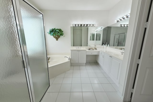 11654 Caracas Blvd, Boynton Beach, FL 33437 - bathroom featuring a garden tub, tile patterned flooring, a shower stall, two vanities, and a sink
