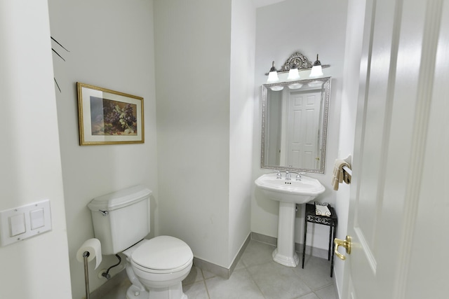 11654 Caracas Blvd, Boynton Beach, FL 33437 - bathroom with tile patterned flooring, a sink, baseboards, and toilet