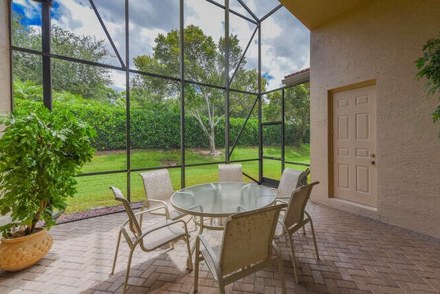 sunroom featuring outdoor dining area