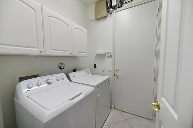 11654 Caracas Blvd, Boynton Beach, FL 33437 - clothes washing area featuring light tile patterned floors, cabinet space, and washing machine and clothes dryer